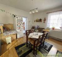 Dining area with a stove and refrigerator in a family house.
