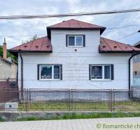 A family house in Sielnica with a metal roof and a metal fence.
