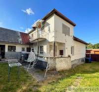 A family house in Sielnica with a yard, garden furniture, and outbuildings.