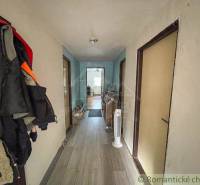 Hallway in a family house with coat racks, flooring, and fans.