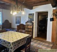 Rustic room with a wooden ceiling, dining table, and peculiar properties.