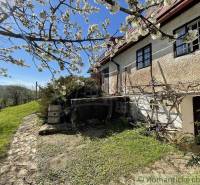 Stone cottage with a garden and flowering trees, ideal for unique properties.