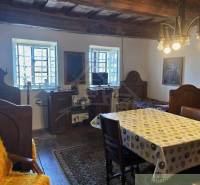 Traditional interior with real estate, wooden beams, and unique lighting, complemented by antique furniture.