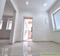 The interior of a family house with large windows and open white doors.