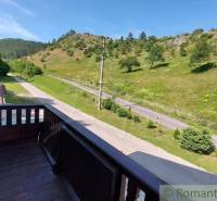 The view from the balcony of a family house in Dobrá Voda to the green landscape and the road.