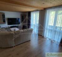 Living room in a family house with a large TV and a comfortable sofa.