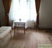 Living room of a family house with antique furniture and wooden flooring.