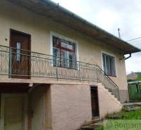 A family house in Fričovce with an external staircase and a garden.