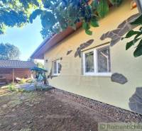 A family house in Komárno with a courtyard, garden furniture, and a barbecue shelter.