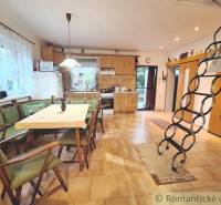 Dining room with stairs and kitchen in a family house.