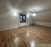 Attic room with a sloped ceiling, lighting and view, family house, wooden floor.