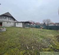 A family house with a garden and a well in a peaceful rural location.