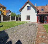 A family house in Malá Lehota with a garden, lawn, and paved path.