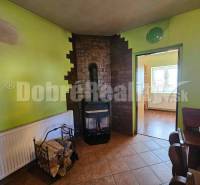 A family house with a fireplace stove, wood, and furniture in a cozy interior.