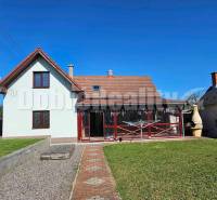 A family house in Malá Lehota with a gable roof and a landscaped garden.