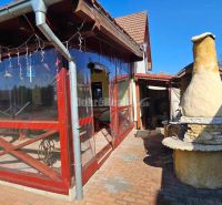 A family house in Malá Lehota with an outdoor fireplace and a glazed terrace, ideal for relaxation.