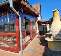 A family house in Malá Lehota with an outdoor brick grill and a covered terrace.