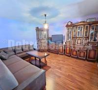Living room in a family house with wooden furniture and a corner sofa.