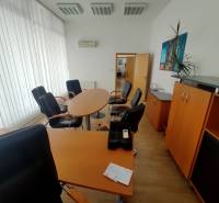 Offices furnished with round tables, chairs, and cabinets.