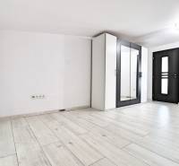A bright room with a parquet floor and a wardrobe in a family house.