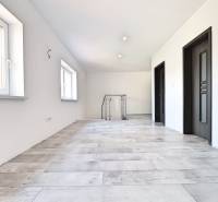 A spacious interior with two windows and dark doors in a family house.