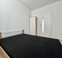 3-room apartment with a bed and a white wardrobe in the room.