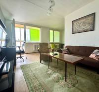 Living room in a 3-room apartment with dark furniture, a map, and a light floor.