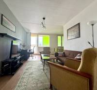 Living room in a 3-room apartment with a sofa, armchairs, and a television.