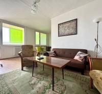 Living room in a 3-room apartment with a sofa, armchairs, and a table.