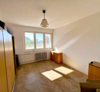 A room with built-in wardrobes and parquet floors in a 2-room apartment.