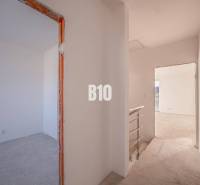 The interior of a family house with unfinished rooms and rough walls.