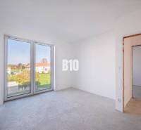 An empty room with a large window in a family house.