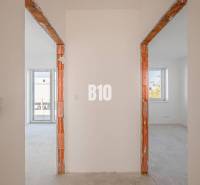 Interior photograph of two rooms in a family house with brick door frames.