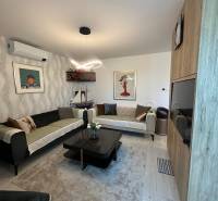 Living room in a family house with sofas, decorations, and paintings on the walls.