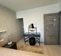 A bedroom in a family house with a dressing table and a mirror.