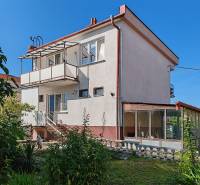A family house on Školská Street in Voderady with a balcony and a glazed veranda.