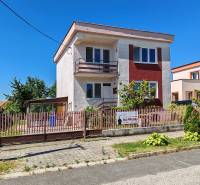 A family house on Školská Street in Voderady with a fenced garden and a gazebo.