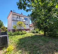 A family house in Voderady on Školská street surrounded by greenery and a garden.