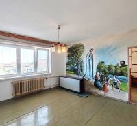 Living room in a family house with a fresco of the Virgin Mary and children on the wall.