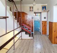 Interior of a family house with wooden paneling and a staircase next to the bathroom.