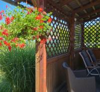 A summer terrace of a family house with flowers and a swimming pool in Trenčianske Jastrabie.