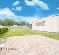 A family house in Dunajský Klátov with a spacious lawn and trees on the property.