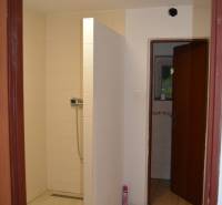 Shower enclosure with side doors, suitable as part of commercial premises.