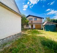 A family house in Sobrance with a spacious garden, garage, and a small shelter on the property.