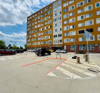 Parking lot in front of the apartment building on Učňovská Street in Košice-Šaca.