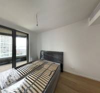 Bedroom with a bed and a terrace in a 2-room apartment.
