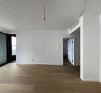 Spacious interior of a 2-room apartment with large windows and wooden flooring.