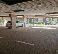An underground parking lot with a white car.