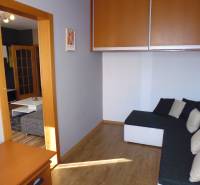 Living room with a sofa and built-in wardrobes in a 3-room apartment.