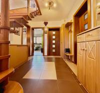 Interior of a family house with a wooden staircase and a modern entrance.